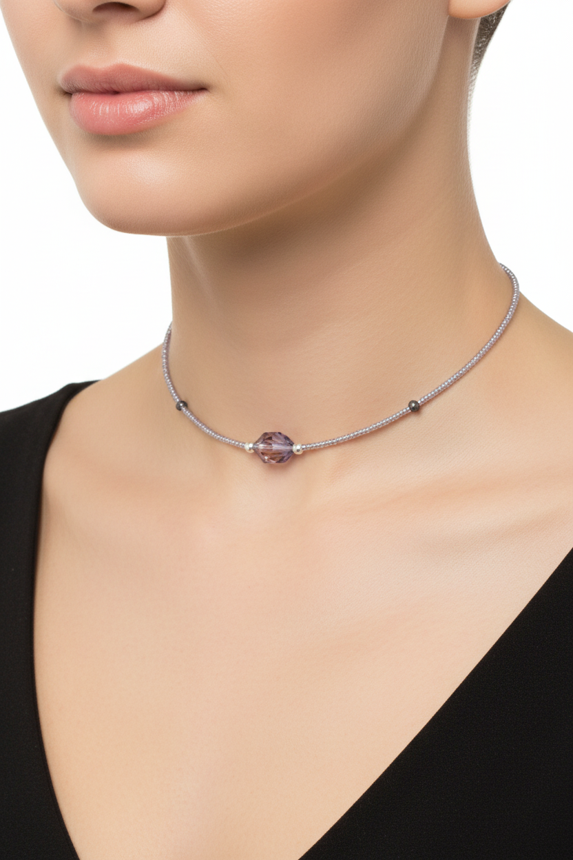 Necklace with a purple pendant worn by a model on a plain background