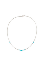 Necklace with turquoise beads on a white background
