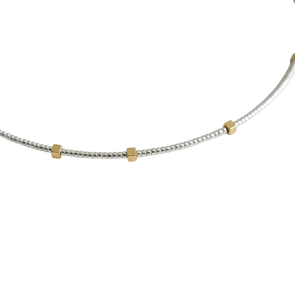 Gilded Thread Necklace | Gold cube beads spaced along a strand of silver.