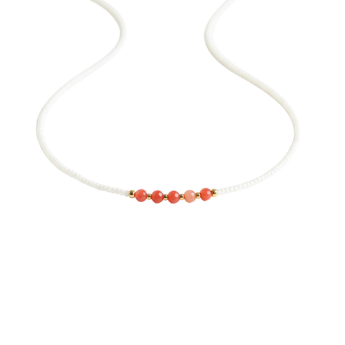 Coral Bloom Necklace - Coral gemstones along a strand of ivory-tone beads.