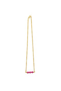 Gold necklace with pink beads on a white background