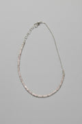 Necklace with pink beads on a gray background