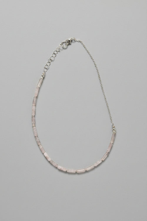 Necklace with pink beads on a gray background